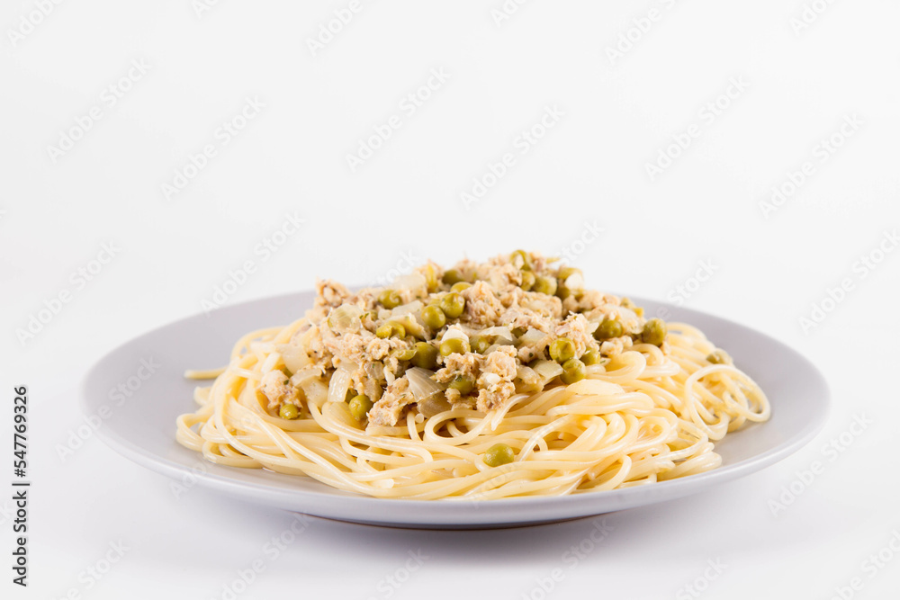 Spaghetti with smoked mackerel and green peas cream sauce on a white background Spaghetti with smoked mackerel and green peas cream sauce on a white background