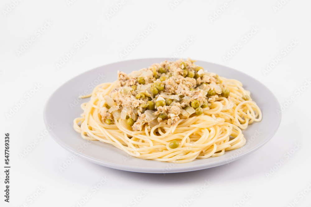 Spaghetti with smoked mackerel and green peas cream sauce on a white background Spaghetti with smoked mackerel and green peas cream sauce on a white background