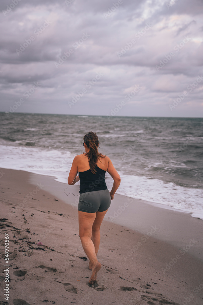 woman running on the beach sport life miami 