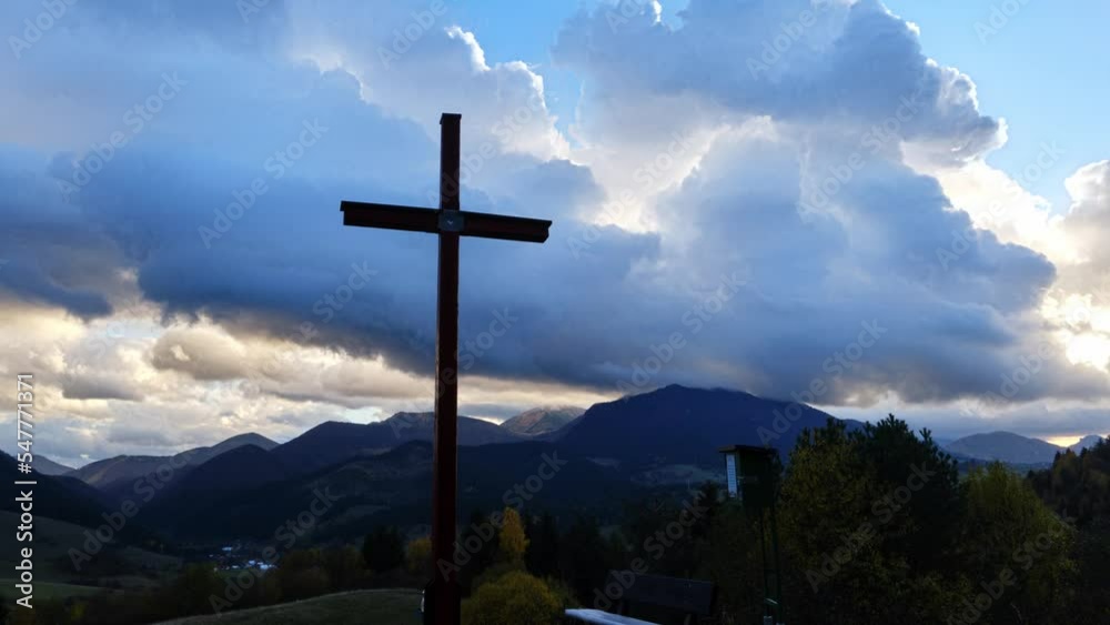Christian cross in mountain rural landscape, clouds in blue sky at dusk. Timelapse Christian cross in mountain rural landscape, clouds in blue sky at dusk. Timelapse
