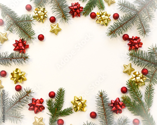 Christmas tree branches, red balls and stars, New Year's decor on a white background. Christmas frame for your text © Uliana
