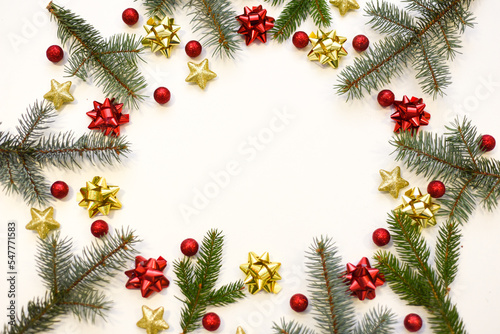 Christmas tree branches  red balls and stars  New Year s decor on a white background. Christmas frame for your text