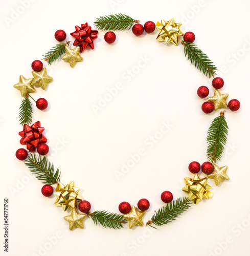 Christmas tree branches, red balls and stars, New Year's decor on a white background. Christmas frame for your text