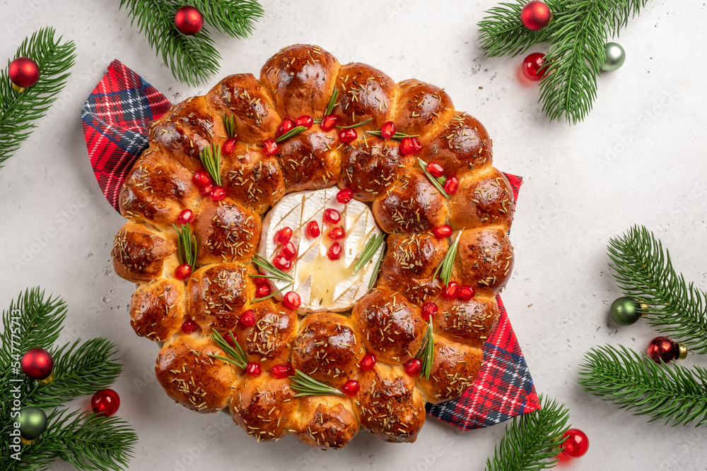 Bread Christmas wreath with cheese topped with rosemary and red pomegranate. Festive monkey bread Bread Christmas wreath with cheese topped with rosemary and red pomegranate. Festive monkey bread