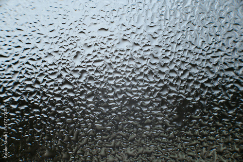 large dew drops on the window after condensation has settled on the window.