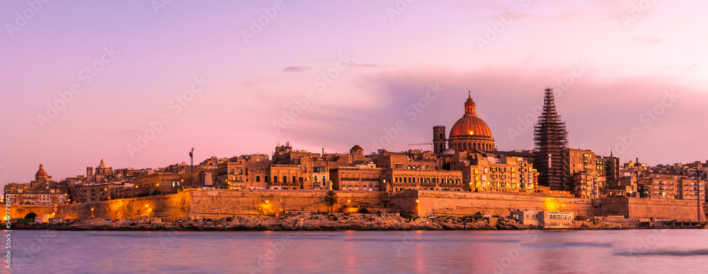 Panorama of Valletta skyline, capitol of Malta. Illuminated architecture at sunset