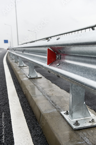 Brand new metallic road barrier for traffic safety on a new constructed road photo