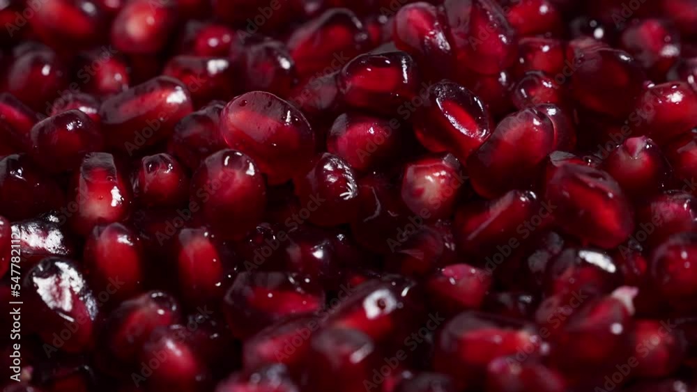 Macro photography of bright red pomegranate fruit seeds. Rotating red ripe pomegranate. High quality 4k footage Macro photography of bright red pomegranate fruit seeds. Rotating red ripe pomegranate. High quality 4k footage