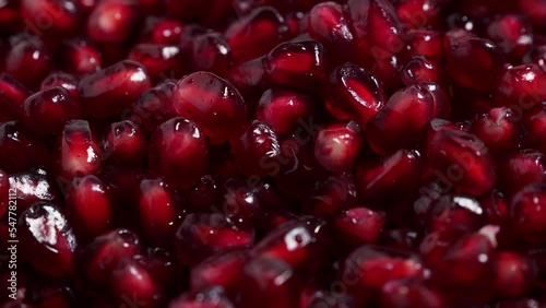 Macro photography of bright red pomegranate fruit seeds. Rotating red ripe pomegranate. High quality 4k footage