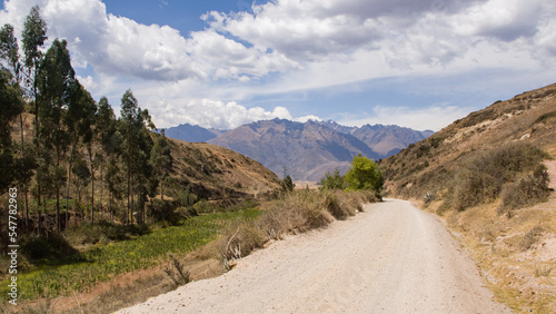 Dry andean landscape with a dirt road going down next to mountain Cusco  Peru