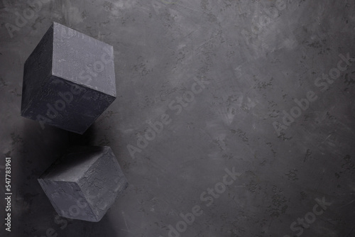 Cement block on floor background as construction concept. Concrete cube with abstract art idea