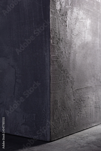 Concrete cube on abstract cement background texture. Wall corner of house