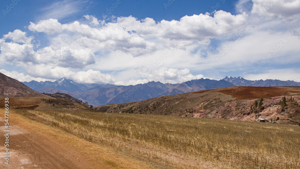 Dry andean landscape and cloudy view dirt road near mountains Cusco, Peru