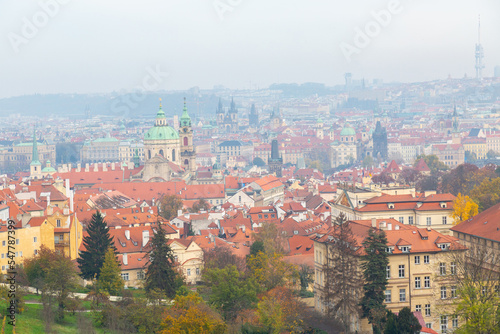 Tourism in Europe. View on old streets of Prague in the morning, city center, Czech Republic, European travel. Typical old buildings with red tile roofs in Prague in foggy day.  © Olga Mishyna