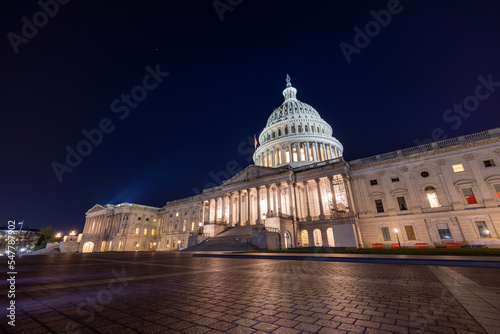 The east side of the United States Capitol Building in Washington  DC on a late autumn night. Spotlights illuminate the Capitol Dome and Statue of Freedom. No people are seen..