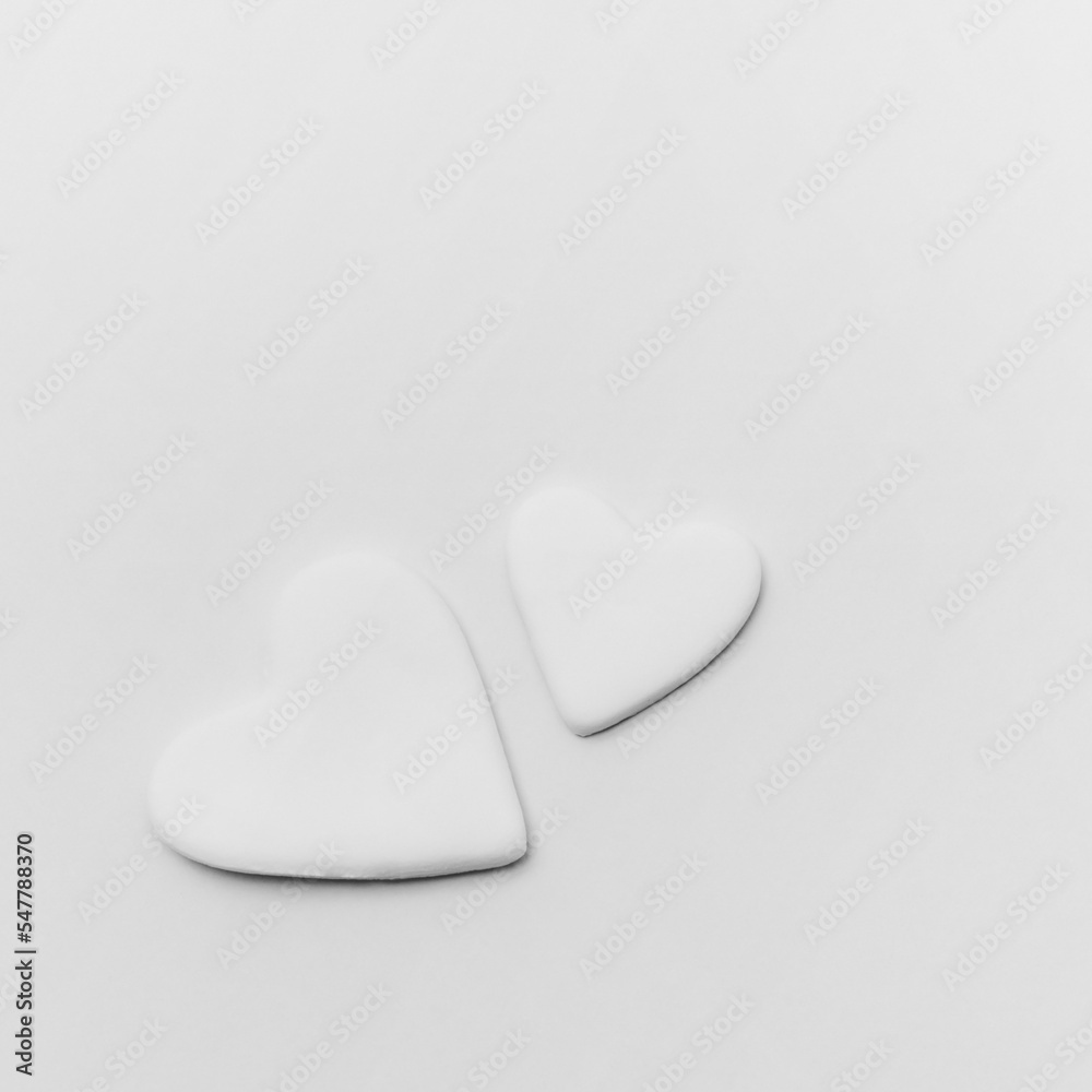 Valentines day background with two white hearts floating isolated on white background. Love card for birthday, anniversary. Love is in the air. Romantic moment. Valentines day background with two white hearts floating isolated on white background. Love card for birthday, anniversary. Love is in the air. Romantic moment.