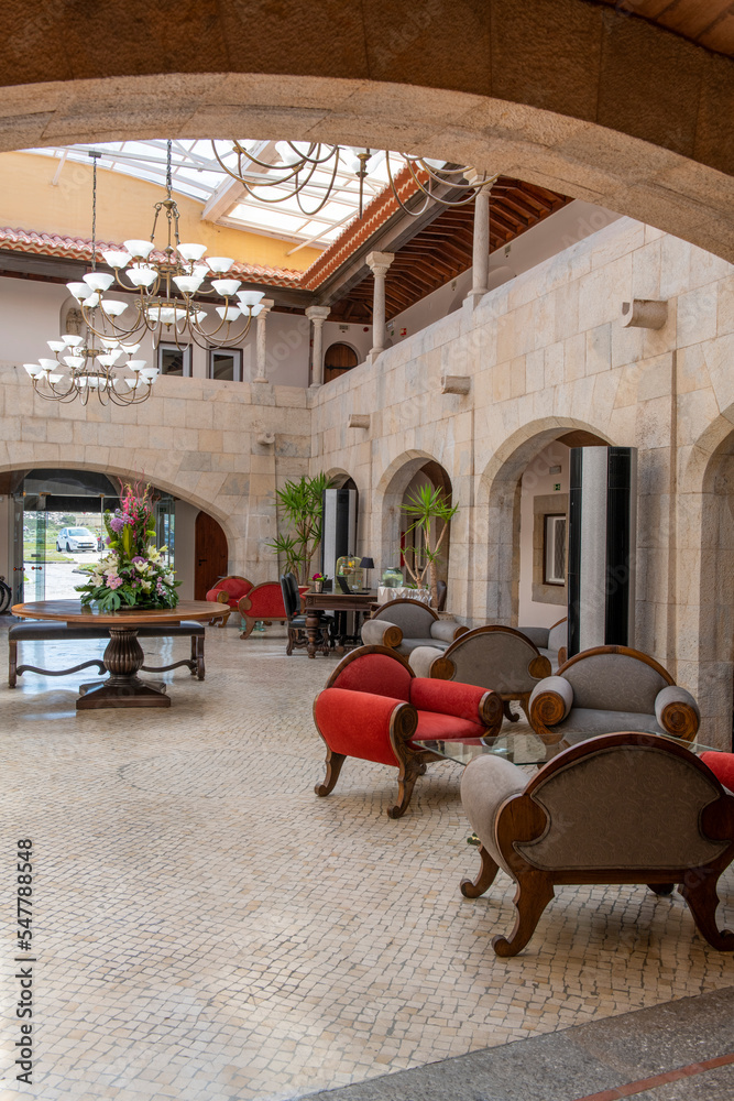 Large lobby with individual gray and red fabric sofas and marble walls Large lobby with individual gray and red fabric sofas and marble walls