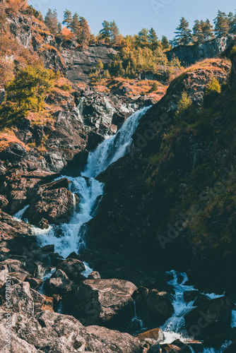 The Låtefossen waterfall in Norway on a sunny autumn day photo