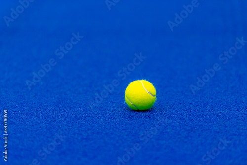 Yellow tennis ball in court on blue turf.  Horizontal sport poster, greeting cards, headers, website © Augustas Cetkauskas