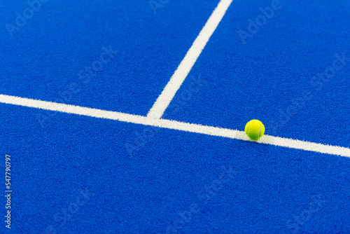 Paddle tennis and tennis ball with white lines on blue court.  Horizontal sport poster, greeting cards, headers, website © Augustas Cetkauskas