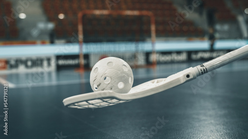 Floorball stick holding ball close to net