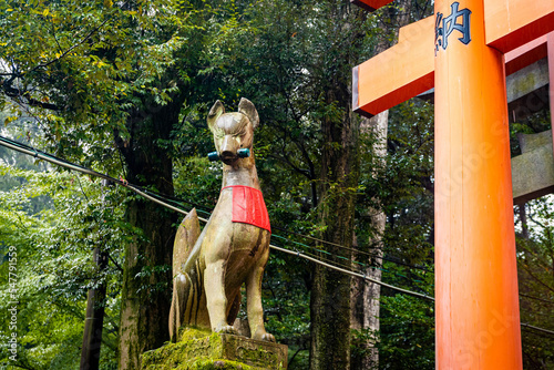 Sacred fox statue sculpture at Fushimi Inari Taisha in Kyoto Japan photo