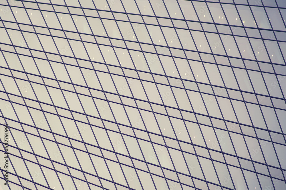 Glass windows of the skyscraper background, copy space. Metal structures with windows of a high-rise building, close-up Glass windows of the skyscraper background, copy space. Metal structures with windows of a high-rise building, close-up