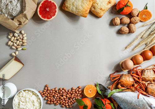 Allergy food concept. allergene - milk, fish, strawberry, bread, eggs, peanuts, citrus, wheat flower and others on grey backgrond