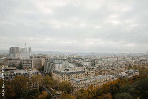 Top view of a European country with lots of green trees and buildings. Image of Paris from above. French state in autumn © Marianna