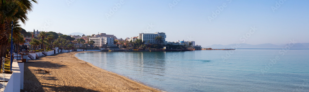 Sandy Beach in a touristic town on Aegean Sea. Ladies Beach in Kusadasi, Turkey. Sunny Morning