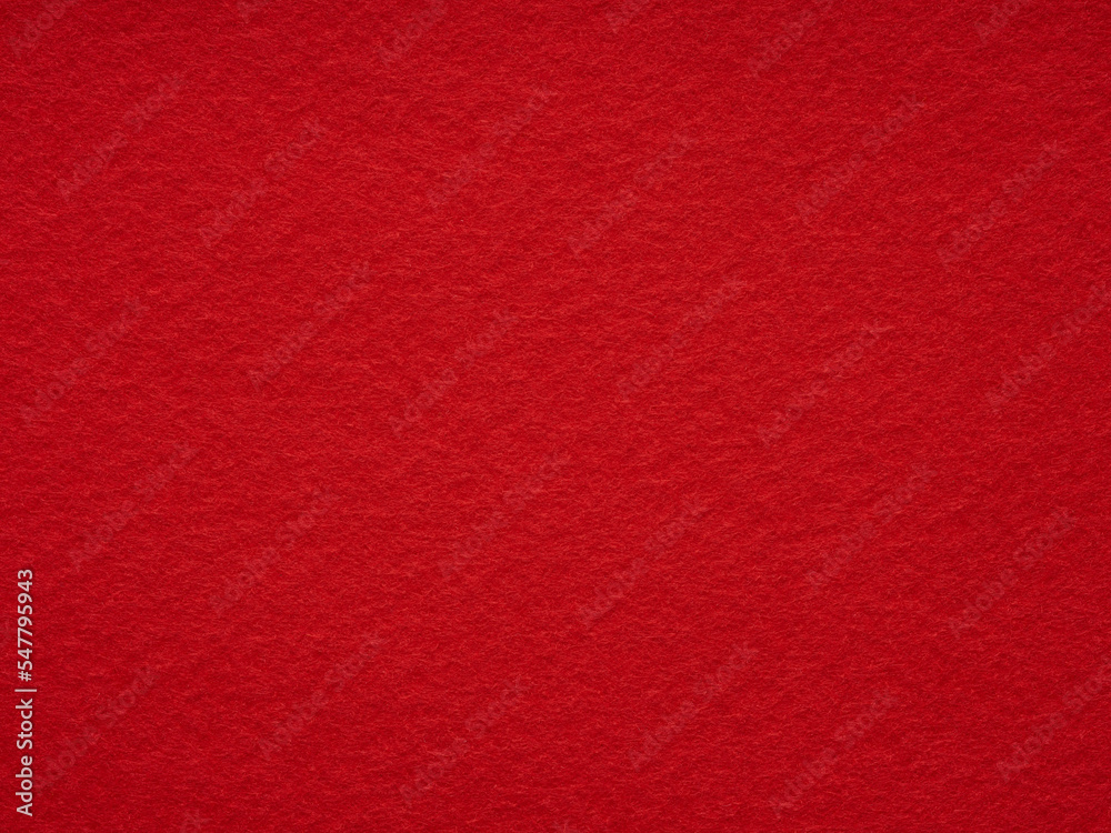 Bright red felt rough texture. Surface of felted fabric texture abstract background. Pattern for text, lettering, patchworkor other art work. Full frame backdrop wallpaper. High resolution photo.