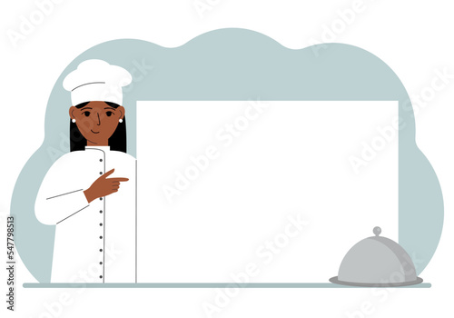 A female cook in uniform and a cap holds a large sheet of paper. Concept for menu, recipe book, blank cookbook or records.