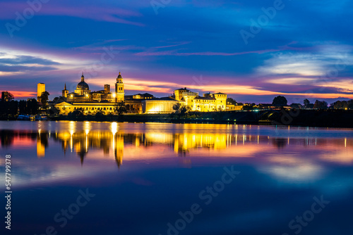 Panoramic evening view of Mantua  Lombardy  Italy  scenic twilight skyline view of the medieval town reflected in the lake waters