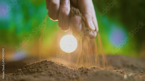 close up of farmers hand planting pumpkin seeds in the ground Fertile ground in which seeds are planted, cultivation in black soil with selective focus. Natural Organic Soil Agriculture. sunrise light photo