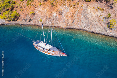 Tropical beach white yacht on blue sea Antalya, Turkey Aerial top view. Concept beautiful travel summer landscape