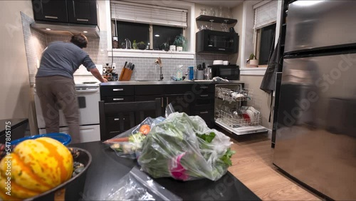 Time lapse of man cleaning kitchen, wiping, messy kitchen, house work, clean up, cooking, dishwasher. 4K 24FPS