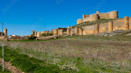 Spring view of main attraction of Berlanga de Duero - dilapidated medieval fortress built by Dukes of Frias enclosed by defensive wall on hill, Spain