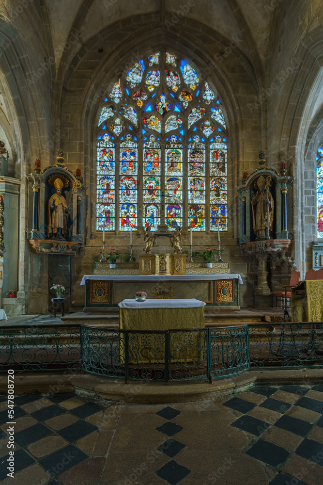 Fototapeta premium Typical beautiful breton Flamboyant Gothic church named Eglise Saint-Ronan de Locronan with altar, Locronan, Brittany, France
