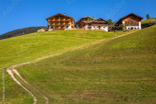 Idyllic Val di Funes in St. Magdalena and chalets, Dolomites alps in Italy
