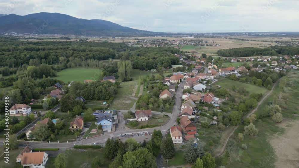 To the right side moving aerial drone top view of the village of Michelbach (Upper-Rhine, Alsace, France)