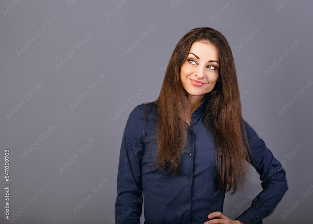 Beautiful confident thinking smiling business woman in blue shirt on grey background with empty copy space for text. Closeup Beautiful confident thinking smiling business woman in blue shirt on grey background with empty copy space for text. Closeup
