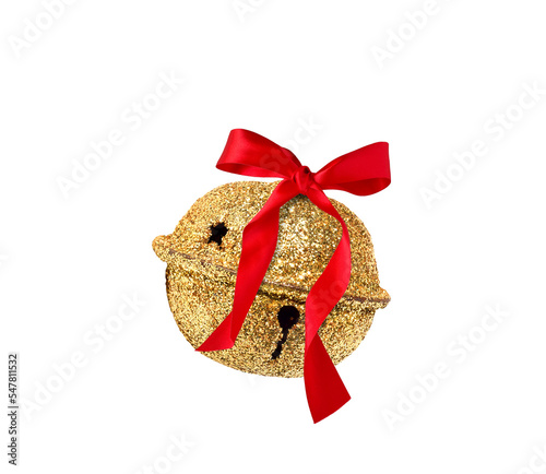 Gold glitter covered jingle bell with red ribbon bow isolated cutout photo