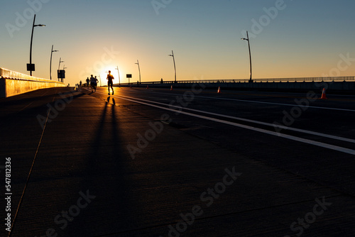 One marathon runner silhouetted in the sunrise 