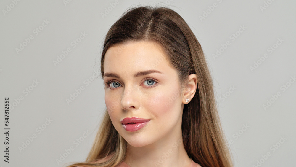 Beautiful young girl looks at the camera after professional makeup. Model poses in front of the camera. An attractive girl with beautiful makeup. Close-up face of a white model with long hair. Beautiful young girl looks at the camera after professional makeup. Model poses in front of the camera. An attractive girl with beautiful makeup. Close-up face of a white model with long hair.