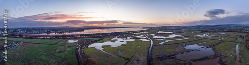 Sunrise over Wetlands and meadows in RSPB Exminster and Powderham Marshe from a drone, Exeter, Devon, England © Maciej Olszewski