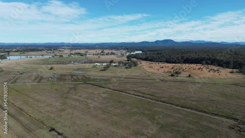 Aerial shot of a plain field beside the Munns Channel in Port Macquarie, New South Wales, Australia photo