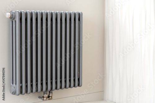 Wallpaper Mural A man's hand holds a heating thermostat knob. The concept of the cost of heating services, the increase in prices for utilities Torontodigital.ca