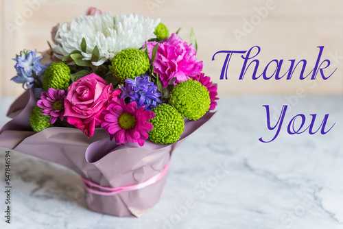 Bouquet with pink rose and lettering thank you, english. bright bouquet of roses, Lisianthus, Alstroemeria and other flowers.Present for springtime holidays.Administrative professional day concept.