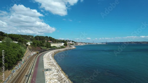 Wallpaper Mural Aerial view following a train on the coastline of sunny Caxias, Lisbon, Portugal Torontodigital.ca