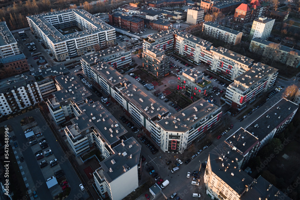 Fototapeta premium Modern residential complex in Wroclaw city, Poland. Aerial view of district with modern residence buildings, courtyards and parked cars.